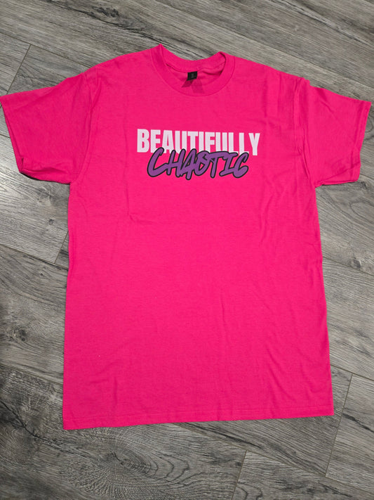 Pink t-shirt with text on a wooden floor